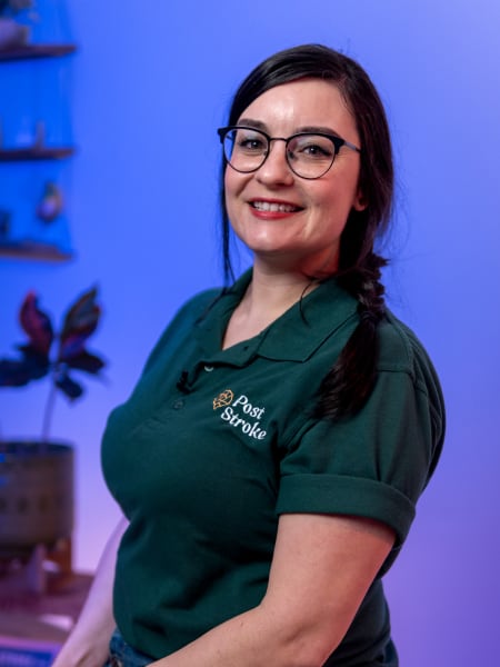 Portrait of Elyse Newland smilling in her green Post Stroke polo shirt